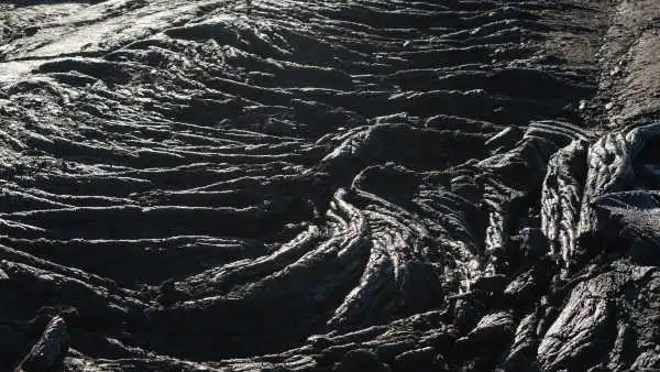 closeup of ripples in black freshly solidified lava